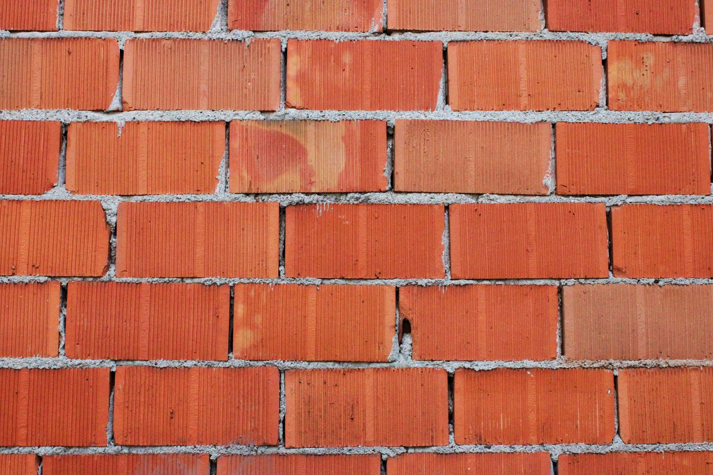 A red brick wall laid in a clean running bond